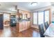 Open concept kitchen with maple cabinets, granite counters, stainless appliances, hardwood flooring and breakfast bar at 6530 Grant Wood Ct, Indianapolis, IN 46256