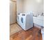 Functional laundry room equipped with modern washer and dryer units, and utility sink at 6530 Grant Wood Ct, Indianapolis, IN 46256