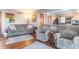 Comfortable living room showcasing neutral furniture, hardwood floors, and open layout to kitchen at 6530 Grant Wood Ct, Indianapolis, IN 46256
