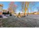 Large backyard with a white picket fence, lawn, and mature trees at 6878 Black Oak East Ct, Avon, IN 46123