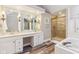 Bathroom features dual sinks, vanity, shower, and tub at 6878 Black Oak East Ct, Avon, IN 46123