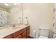 Bathroom with wood vanity, tan countertops and large mirror at 6878 Black Oak East Ct, Avon, IN 46123