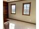 Bedroom features a built-in bookshelf, elegant dark trim, and two sunlit windows, offering charm and functionality at 6878 Black Oak East Ct, Avon, IN 46123