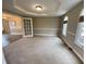 Neutral bonus room features white trim, chair rail, tray ceiling, and French doors at 6878 Black Oak East Ct, Avon, IN 46123