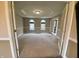Bonus room features neutral carpet and trim, tray ceiling, and glass French doors at 6878 Black Oak East Ct, Avon, IN 46123