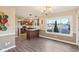 Bright dining room featuring a large window, updated flooring, and modern light fixture at 6878 Black Oak East Ct, Avon, IN 46123