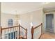 Bright foyer featuring a view of the front door, an elegant chandelier, and wood railings at 6878 Black Oak East Ct, Avon, IN 46123