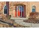 Inviting front entrance with red door, sidelights, decorative wreath, and charming arched windows at 6878 Black Oak East Ct, Avon, IN 46123