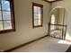 Hallway featuring natural light with elegant trim and a railing with an archway, creating a seamless transition at 6878 Black Oak East Ct, Avon, IN 46123
