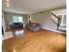 Open-concept living room featuring hardwood floors and staircase access at 6878 Black Oak East Ct, Avon, IN 46123