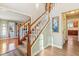 Grand staircase with wooden railing and carpeted steps leading to the upper level at 6878 Black Oak East Ct, Avon, IN 46123