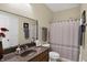 Bathroom featuring single sink vanity, large mirror, and shower with curtain at 700 Greenford N Trl, Carmel, IN 46032