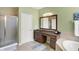 Bright bathroom with walk-in shower, vanity, and a large mirror at 700 Greenford N Trl, Carmel, IN 46032