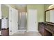 Bathroom featuring a shower, a vanity with a sink, and a doorway to another room with a chest of drawers at 700 Greenford N Trl, Carmel, IN 46032
