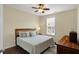 Comfortable bedroom with ceiling fan, window and stylish bedding at 700 Greenford N Trl, Carmel, IN 46032