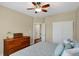 Comfortable bedroom featuring dresser, ceiling fan, large window and closet at 700 Greenford N Trl, Carmel, IN 46032