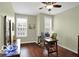 A warm bedroom or office area featuring hardwood floors, natural light, and a neutral color palette at 700 Greenford N Trl, Carmel, IN 46032