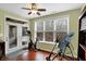 Bright exercise room features exercise equipment, a ceiling fan, and a sliding glass door to an outdoor patio at 700 Greenford N Trl, Carmel, IN 46032