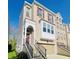 Charming townhome featuring a red front door, attached garage, and a combination of siding and brick at 700 Greenford N Trl, Carmel, IN 46032