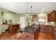 Kitchen featuring a center island, stainless steel appliances, dark wood cabinets, and hardwood floors at 700 Greenford N Trl, Carmel, IN 46032