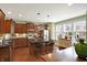 Kitchen featuring a center island, stainless steel appliances, dark wood cabinets, and granite counters at 700 Greenford N Trl, Carmel, IN 46032