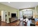 Cozy living room with hardwood floors, a flat-screen TV, and comfortable leather furniture at 700 Greenford N Trl, Carmel, IN 46032