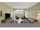 Open-concept living room featuring hardwood floors, a ceiling fan, and ample natural light at 700 Greenford N Trl, Carmel, IN 46032