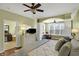 Inviting main bedroom with adjacent bathroom, ceiling fan, and a cozy seating area at 700 Greenford N Trl, Carmel, IN 46032