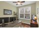 Bright home office featuring a ceiling fan, large window, and modern desk with dual monitors at 700 Greenford N Trl, Carmel, IN 46032