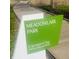 Meadowlark Park sign in bright green, offering a glimpse of the natural beauty and recreational opportunities at 700 Greenford N Trl, Carmel, IN 46032