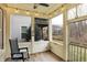 Relaxing screened porch featuring a ceiling fan and views of the community at 700 Greenford N Trl, Carmel, IN 46032