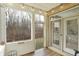 Cozy screened porch with views of the backyard and surrounding nature at 700 Greenford N Trl, Carmel, IN 46032