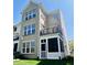 The rear exterior of the building is three stories with multiple large windows and a screened in porch at 700 Greenford N Trl, Carmel, IN 46032