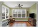 Sitting area with rocking chair, large windows, and a ceiling fan at 700 Greenford N Trl, Carmel, IN 46032