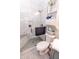 Bathroom with a shower, toilet, and storage shelf at 7221 Broyles Ln, Indianapolis, IN 46217
