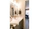 Bathroom featuring a sink, a mirror, and a view into the bedroom at 7221 Broyles Ln, Indianapolis, IN 46217