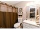 Cozy bathroom with a granite vanity, decorative mirror, and warm brown shower curtain at 7221 Broyles Ln, Indianapolis, IN 46217