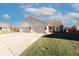 Charming single-Gathering home featuring a 2-car garage, landscaped yard, and inviting curb appeal on a sunny day at 7221 Broyles Ln, Indianapolis, IN 46217