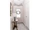 Charming foyer featuring a decorative table, a mirror, and a view of the glass-paned front door at 7221 Broyles Ln, Indianapolis, IN 46217