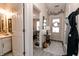Welcoming foyer with stylish decor, showcasing a glimpse of the bedroom and an adjacent half-bathroom at 7221 Broyles Ln, Indianapolis, IN 46217