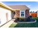 Inviting front entrance with brick accents, a decorative wreath on the door, and well-maintained landscaping at 7221 Broyles Ln, Indianapolis, IN 46217
