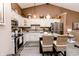 Beautiful kitchen with white cabinets, stainless steel appliances, granite countertops, and wicker seating at the island at 7221 Broyles Ln, Indianapolis, IN 46217