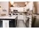 The kitchen features an island, stainless appliances, tile backsplash, and ample cabinet space at 7221 Broyles Ln, Indianapolis, IN 46217