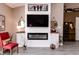 Living room featuring a modern fireplace, mounted TV, shiplap accent wall, and decor at 7221 Broyles Ln, Indianapolis, IN 46217