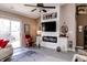 Living room with fireplace, flat-screen TV, ceiling fan, and sliding glass doors at 7221 Broyles Ln, Indianapolis, IN 46217