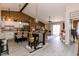 Open-concept living space with modern flooring, a breakfast bar, a dining area and inviting natural light at 7221 Broyles Ln, Indianapolis, IN 46217