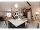 Spacious open-concept living space with hardwood floors, an island, and views of the fireplace and kitchen at 7221 Broyles Ln, Indianapolis, IN 46217