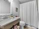 Simple bathroom with a neutral color scheme, featuring a white sink, toilet, and shower with curtain at 817 Hamilton St, Lebanon, IN 46052