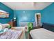 Bedroom with blue walls, featuring a TV, dresser, and beds in disarray at 817 Hamilton St, Lebanon, IN 46052