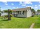 Side view of a cozy single-story home with a green lawn and mature trees at 817 Hamilton St, Lebanon, IN 46052